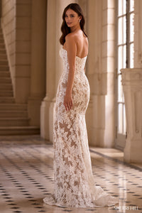 Woman wearing a white lace gown in an elegant interior setting