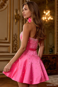 Woman wearing a pink beaded dress in an elegant interior setting