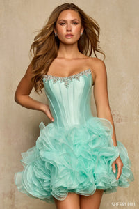 Light green strapless dress with ruffled skirt on a model against a beige background