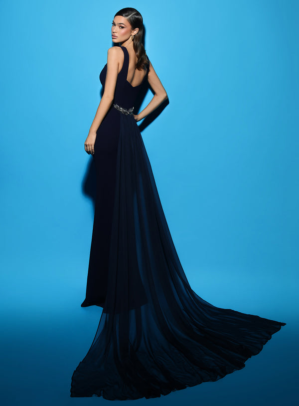 Tarik Ediz 53104 Crepe Column Evening Dress with Train - A sophisticated evening dress featuring a column silhouette, train, overskirt, shoulder straps, and brooch-style embellishments for an elegant and glamorous look.