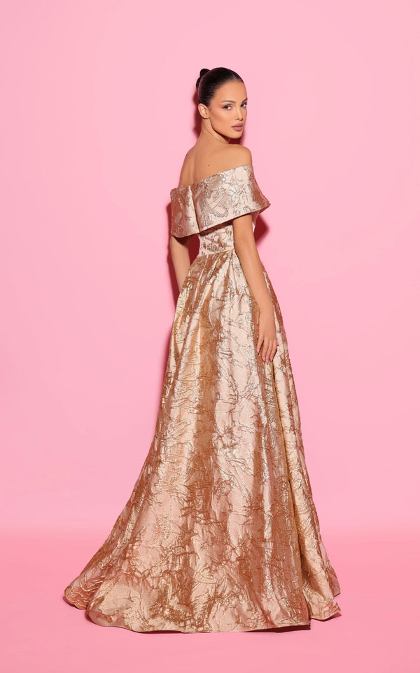 Model wearing the Tarik Ediz 55082 off-the-shoulder A-line gown with a structured bodice and front slit.  Back View.