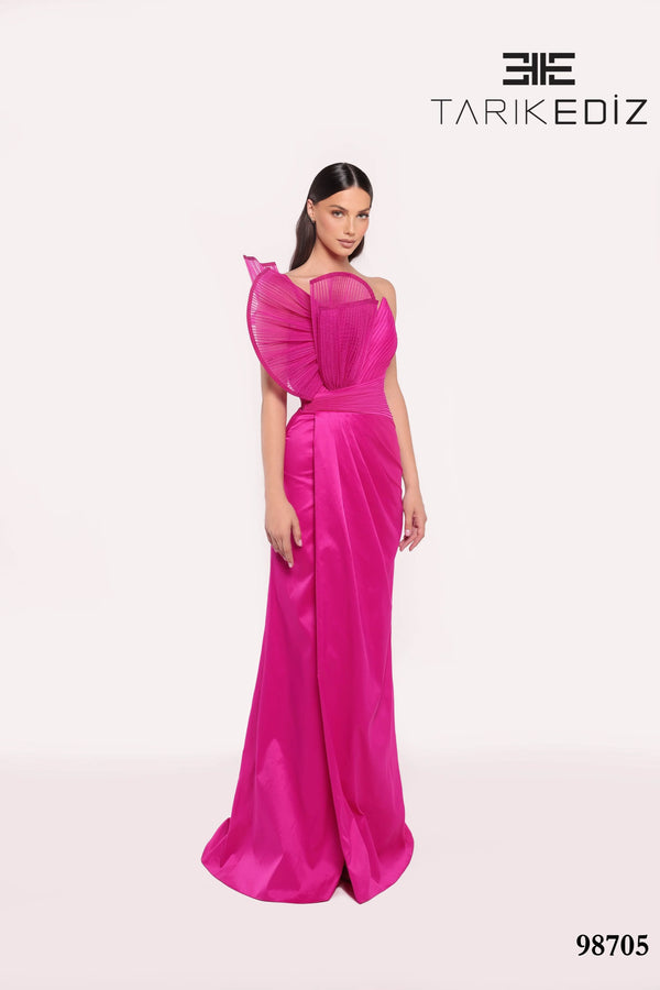 Woman wearing a orchid evening gown with a brand logo in the corner