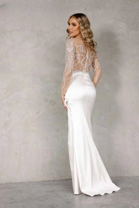 Stunning white evening dress by Terani with sheer embellished bodice and draped satin skirt | Madeline's Boutique