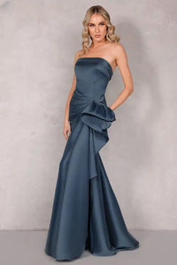 A stunning Mikado evening dress by Terani with an off-shoulder neckline, open back, and a draped bow feature on the waist. Perfect for evening events and as a mother-of-the-bride or mother-of-the-groom dress.
