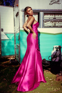 A stunning Mikado evening dress by Terani with an off-shoulder neckline, open back, and a draped bow feature on the waist. Perfect for evening events and as a mother-of-the-bride or mother-of-the-groom dress.  Color Fuschia in the picture.