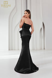 Model wearing Terani Couture 251E4231 one-shoulder gown with ruffle detail and floor-length silhouette