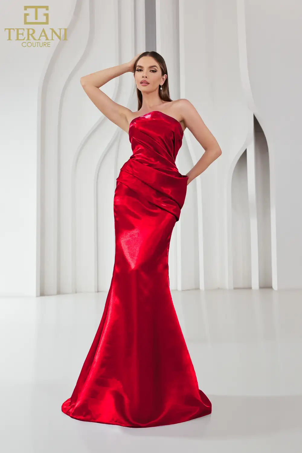 Model wearing Terani Couture 251E4231 one-shoulder gown with ruffle detail and floor-length silhouette