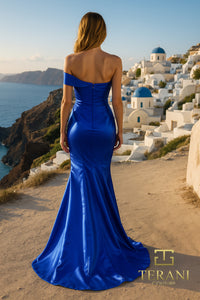 Model wearing Terani 252E5162 off-shoulder gown with draped bodice, rosette detail at hip, and fit-and-flare silhouette.  Model is wearing the color royal.  Back view of the dress.