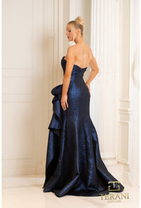 Model wearing Terani 252E5200 strapless metallic jacquard fit and flare gown with side draping detail.  Model is wearing navy.