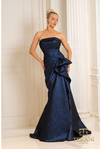 Model wearing Terani 252E5200 strapless metallic jacquard fit and flare gown with side draping detail.  Model is wearing navy.