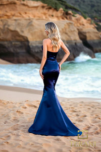 Model wearing Terani 252E5513 one-shoulder shimmer organza evening gown with peplum waist accent and fitted flared silhouette.  Color Navy.