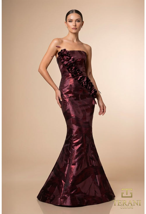 Model wearing the Terani 261E6259 straight neck mermaid gown with floral appliqué detailing and fitted silhouette.