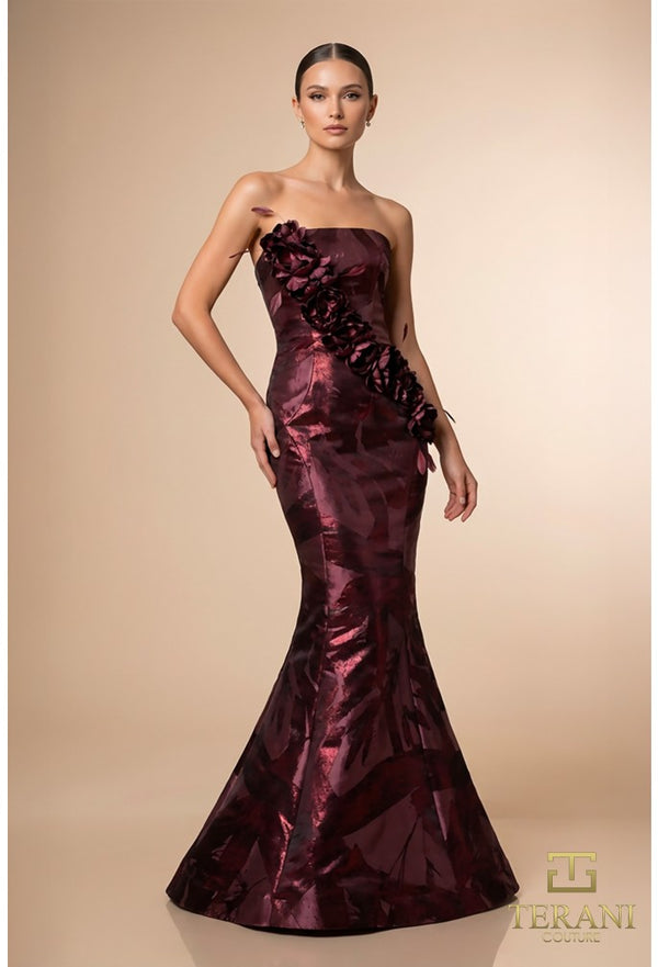 Model wearing the Terani 261E6259 straight neck mermaid gown with floral appliqué detailing and fitted silhouette.