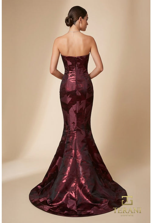 Model wearing the Terani 261E6259 straight neck mermaid gown with floral appliqué detailing and fitted silhouette.