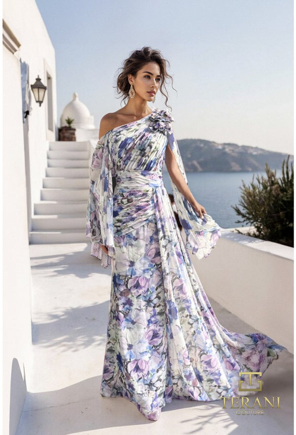 Woman in a floral one-shoulder dress standing on a white staircase with a scenic background.