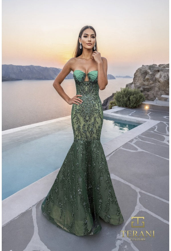 Model wearing the Terani 261GL6001 sweetheart beaded mermaid gown with fitted silhouette, keyhole neckline detail, and flowing skirt at a luxury resort setting.