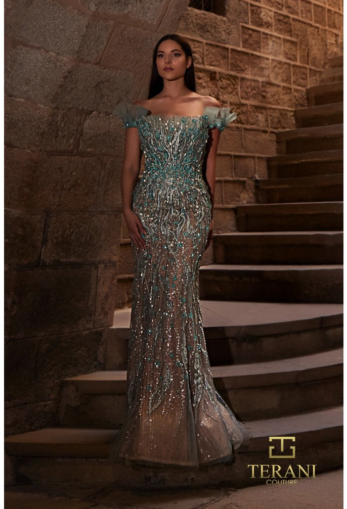 Woman in a sparkling evening gown standing on stone steps with 'Terani Couture' branding.