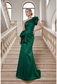 Model wearing Terani 262E7132 one-shoulder mermaid gown in the color emerald with draped bodice, statement bow accents, fitted silhouette, and sweep train.