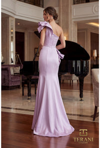 Woman in a lavender evening gown standing in a elegant room with a piano.