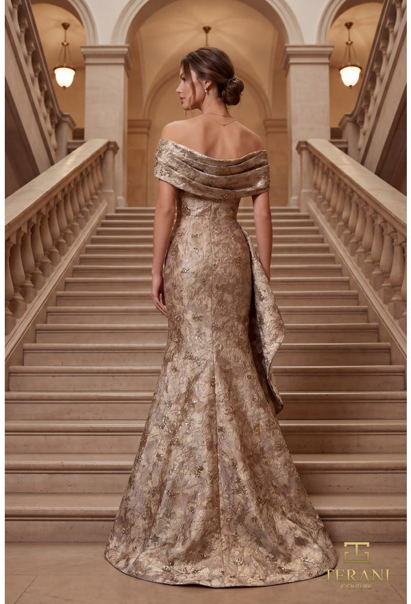 Woman in a gold evening gown standing on a staircase with 'Terani' branding.