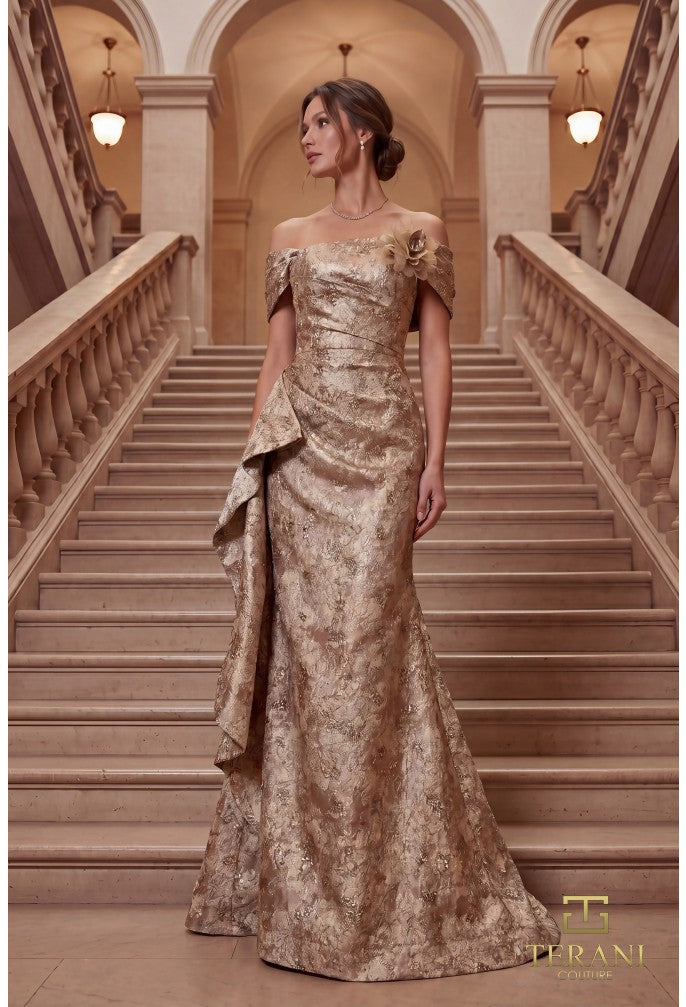 Woman in a gold evening gown standing on a staircase in an elegant building