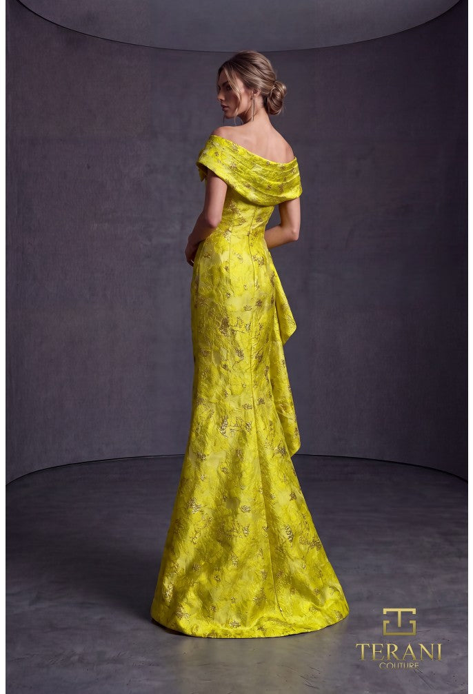 Woman wearing a lemon yellow evening gown with floral details against a gray background, Terani Couture branding visible.