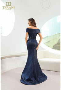 Model wearing Terani Couture 241M2771 off-the-shoulder beaded trumpet gown with fitted bodice and elegant flared skirt in navy back view.