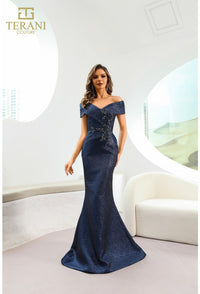Model wearing Terani Couture 241M2771 off-the-shoulder beaded trumpet gown with fitted bodice and elegant flared skirt in navy front view.