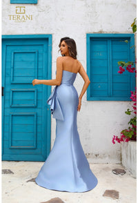 Model wearing Terani Couture 251E4265 off-shoulder pleated gown with fitted silhouette and high slit, perfect for gala, red carpet, or formal evening event.