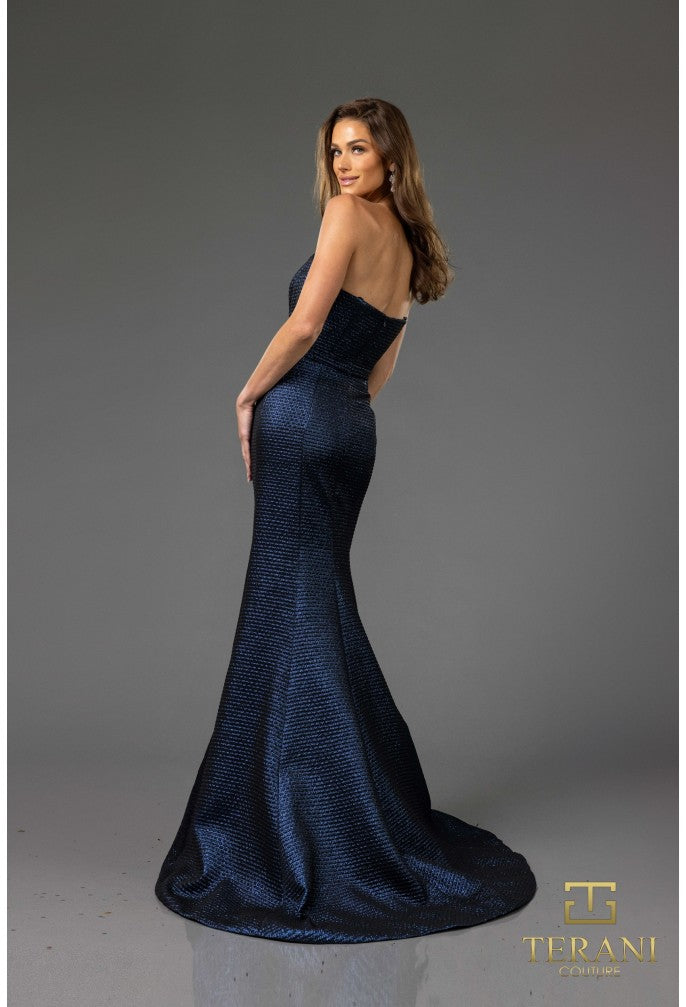 Woman wearing a blue evening gown with a gray background