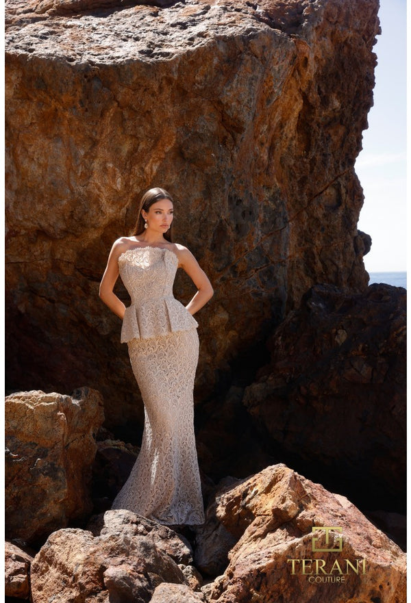 Woman in a champagne color evening gown standing among rocky cliffs with 'Terani Couture' branding.