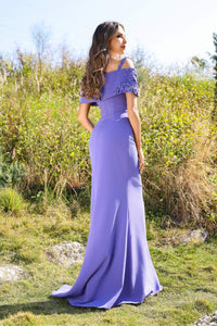 Model wearing Terani Couture 252M5347 cold shoulder evening gown with draped sleeves and fitted silhouette.
