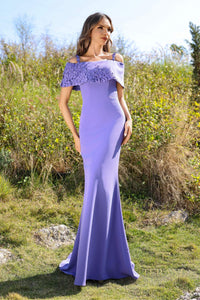 Model wearing Terani Couture 252M5347 cold shoulder evening gown with draped sleeves and fitted silhouette.