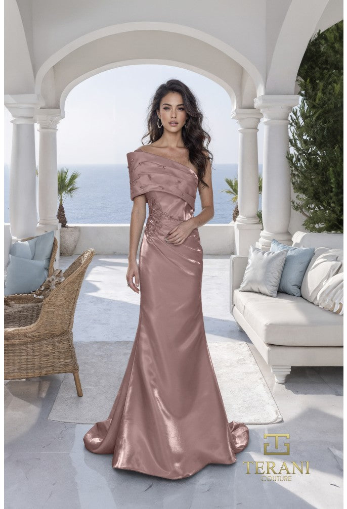 Woman in a espresso colored evening gown standing in an outdoor setting with ocean view
