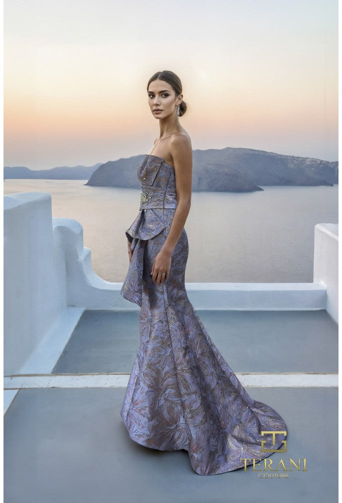 Model wearing Terani Couture 261E6269 strapless sculpted evening gown with structured bodice and draped skirt details.
