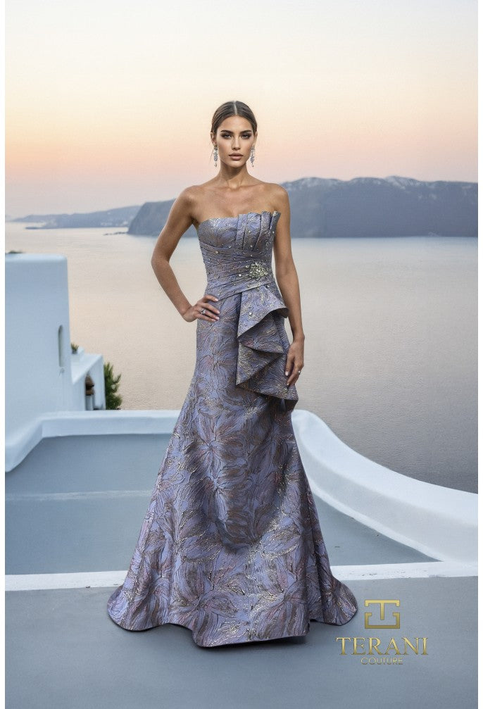 Model wearing Terani Couture 261E6269 strapless sculpted evening gown with structured bodice and draped skirt details.