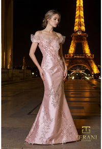 Model wearing the Terani Couture 261E6270 off-the-shoulder fitted gown with floral embellishments and a sweep train.