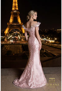 Model wearing the Terani Couture 261E6270 off-the-shoulder fitted gown with floral embellishments and a sweep train.