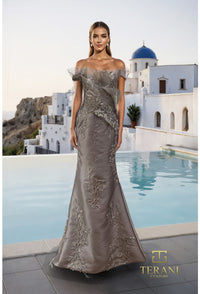 Model wearing the Terani Couture 261E6270 off-the-shoulder fitted gown with floral embellishments and a sweep train.