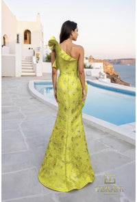 Woman in a yellow one-shoulder dress standing by a pool with a scenic background
