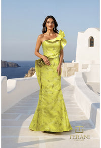 Woman in a yellow evening gown standing on a Mediterranean-style staircase with ocean view.