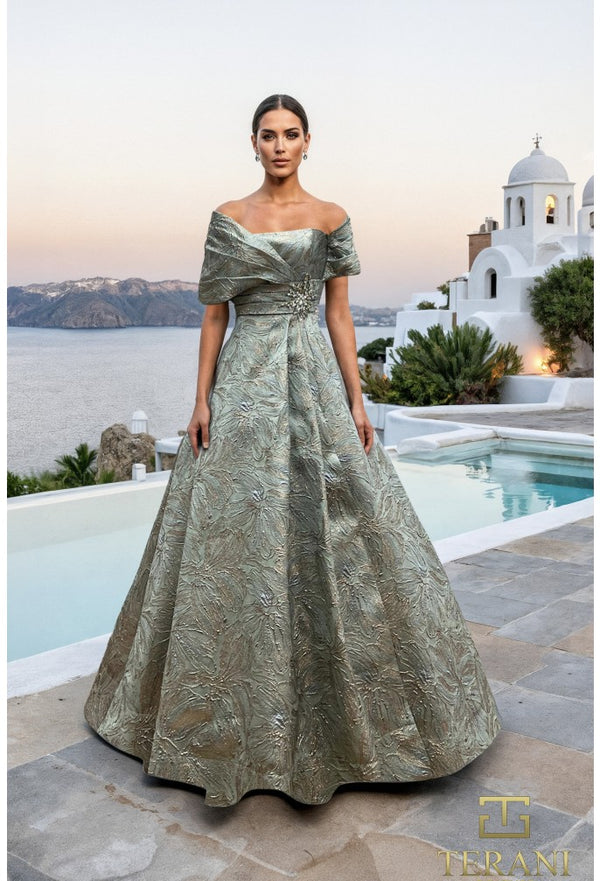 Woman in a green evening gown standing by a pool with a scenic background