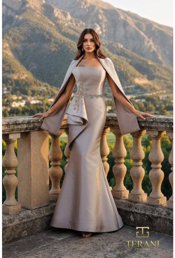 Woman in a elegant dress standing on a balcony with mountains in the background, Terani brand visible.