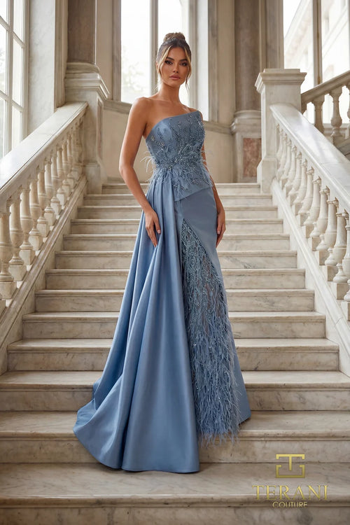 Model wearing Terani Couture 262E7052 one-shoulder evening gown with an embellished bodice, feather-inspired detailing, fitted skirt, and overskirt.  Front View.