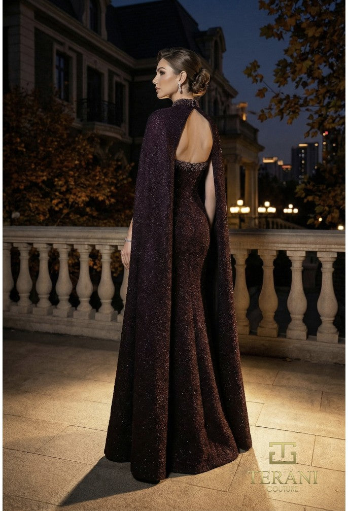 Model wearing Terani Couture 262E7125 fitted evening gown with high-neck cape sleeves, sweetheart bodice, open back, and floor-length silhouette.