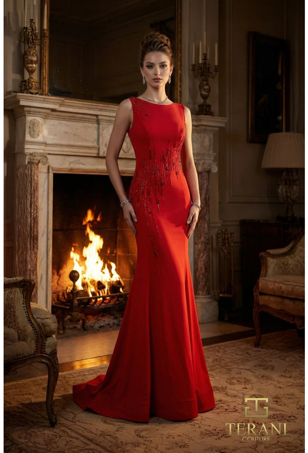 Woman in a red dress standing in a room with a fireplace, wearing jewelry.