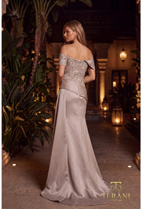 A woman wearing a floor-length off-the-shoulder evening gown with a heavily embellished lace bodice and a satin skirt, standing in a warmly lit courtyard with plants and lanterns. The Terani Prompts logo is visible in the bottom right corner.