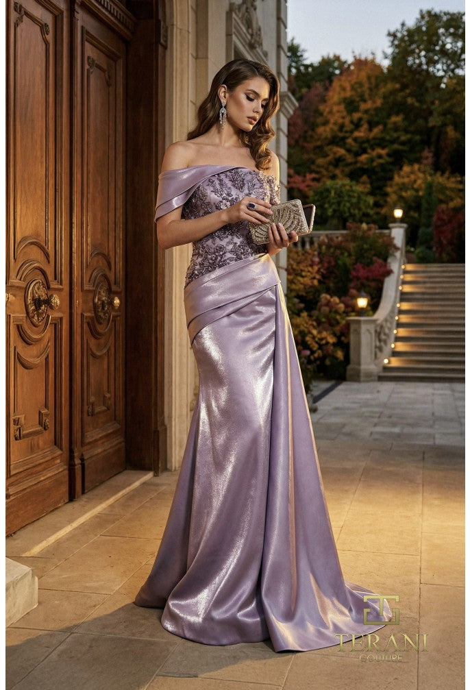 Woman in a periwinkle evening gown standing in front of a wooden door with 'Terani' branding.