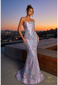 Woman in a strapless, embellished evening gown on a rooftop with a cityscape background