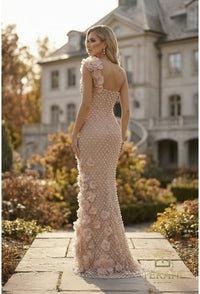 Model wearing Terani Couture 262GL7152 one-shoulder evening gown featuring floral appliqués, intricate beadwork, and a fitted floor-length silhouette.